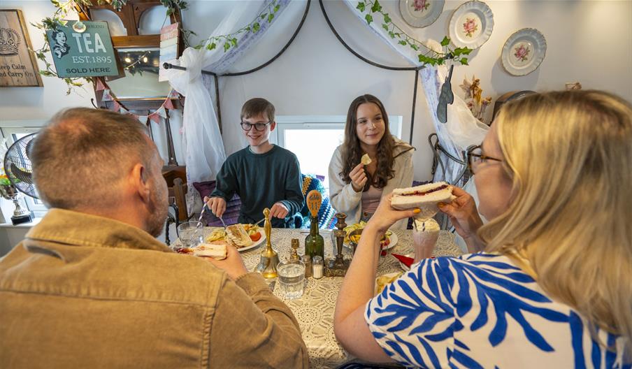 Family enjoying food and drink at The Fairydust Emporium in Silloth, Cumbria