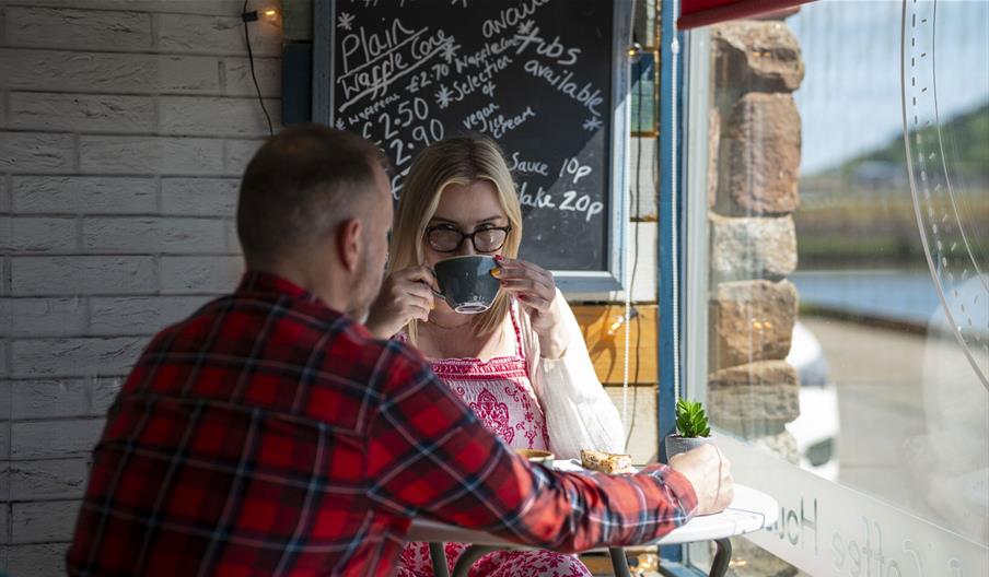 Visitors having coffee at The Wharf Ice Cream and Coffee House in Maryport, Cumbria