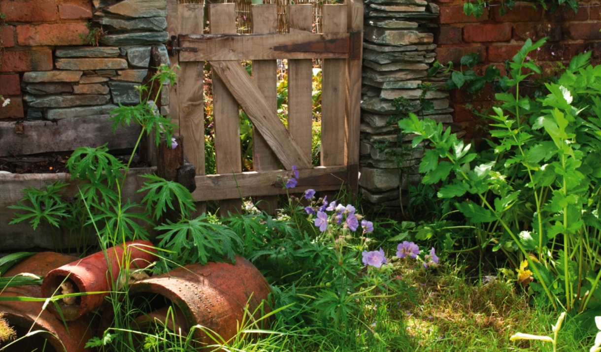 Garden plants and decor at The Peter Rabbit Garden at The World of Beatrix Potter in Bowness-on-Windermere, Lake District