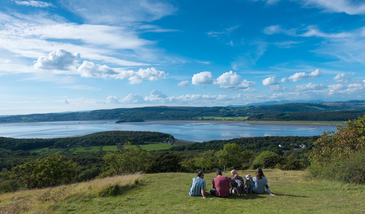 Friends sat by Arnside Knott looking over the river Kent