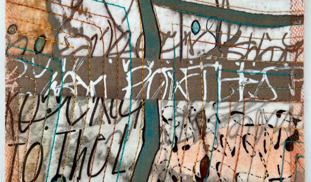 a colourful quilt depicitng the seascape of white cliffs and the sea