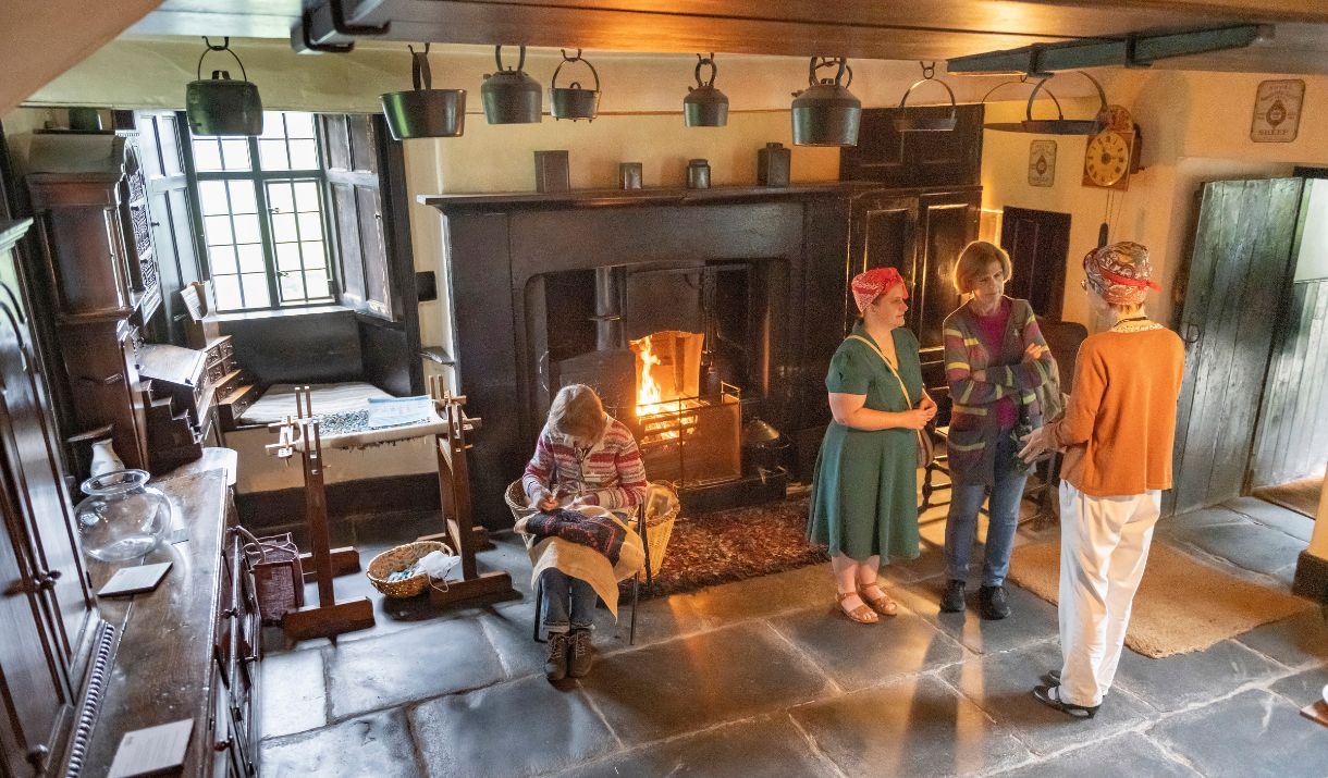 People inside an old farmhouse