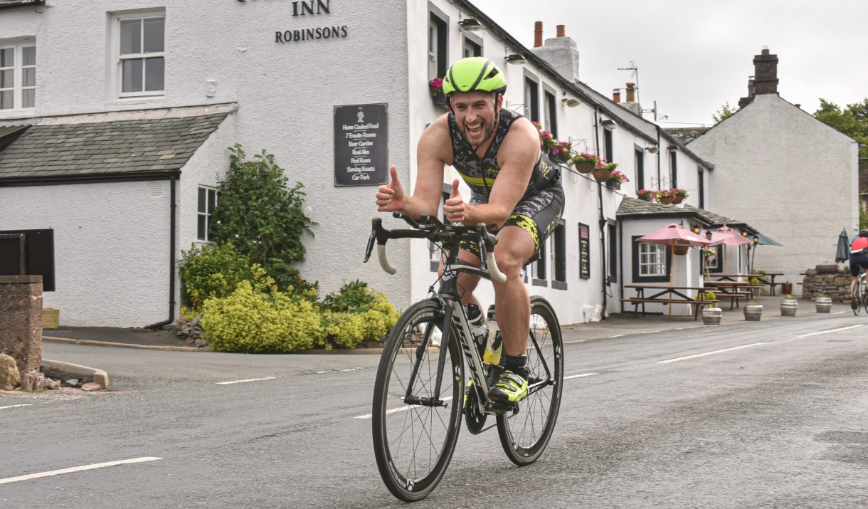 Man smiling at camera on bike