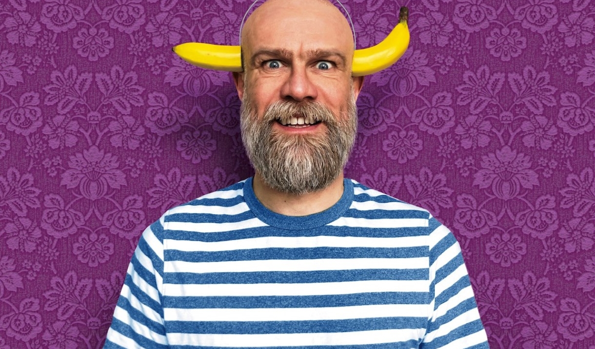 person posing with a banana on their head