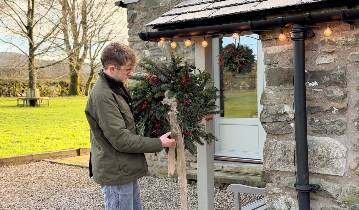 Dan (RHS Gold Medallist from Dan's Plants) holding up a traditional fresh Christmas wreath, one like you would make at Dan's Plants Christmas Wreath W