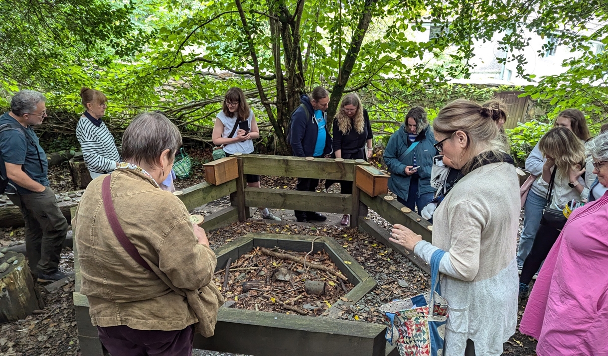 Photograph of a group of people gathered together in a woodland