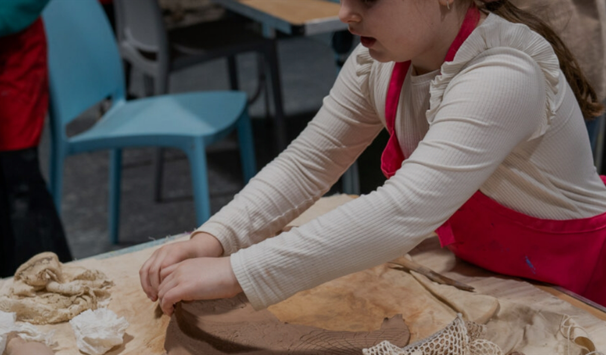 A child moulding clay