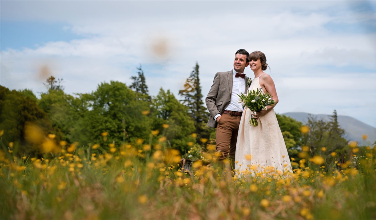 Happy Couple Posing for Wedding Photos at Armathwaite Hall Hotel and Spa in Bassenthwaite, Lake District