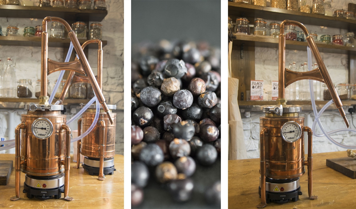 Stills and Juniper Berries at Gin Making Workshops at Black Cat Distillery at Brougham Castle near Penrith, Cumbria