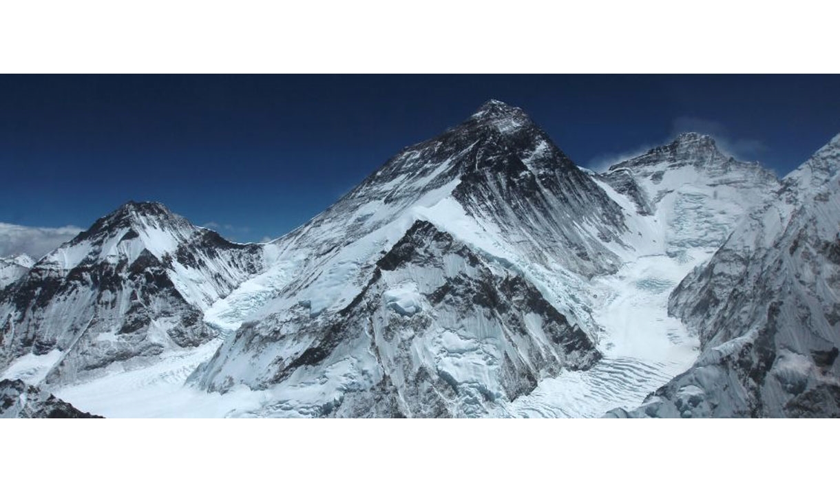 Snow-covered mountain range with deep blue sky