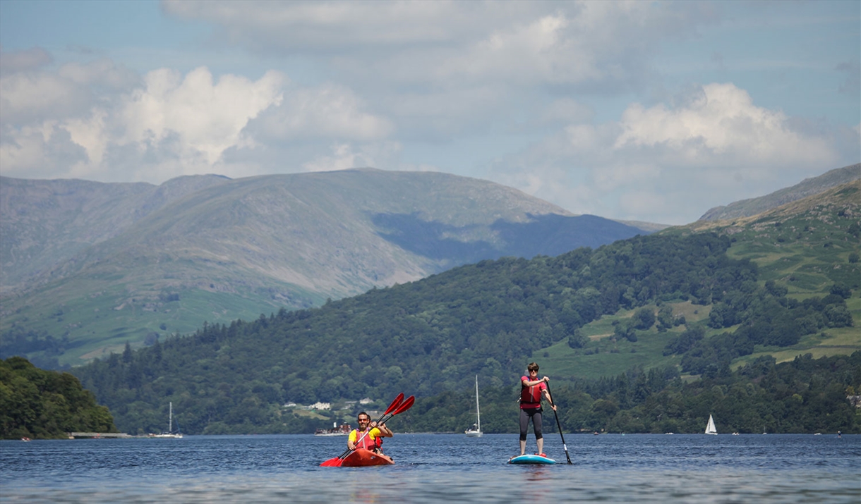 Visitors Kayaking and Paddleboarding at Windermere Canoe Kayak in the Lake District, Cumbria