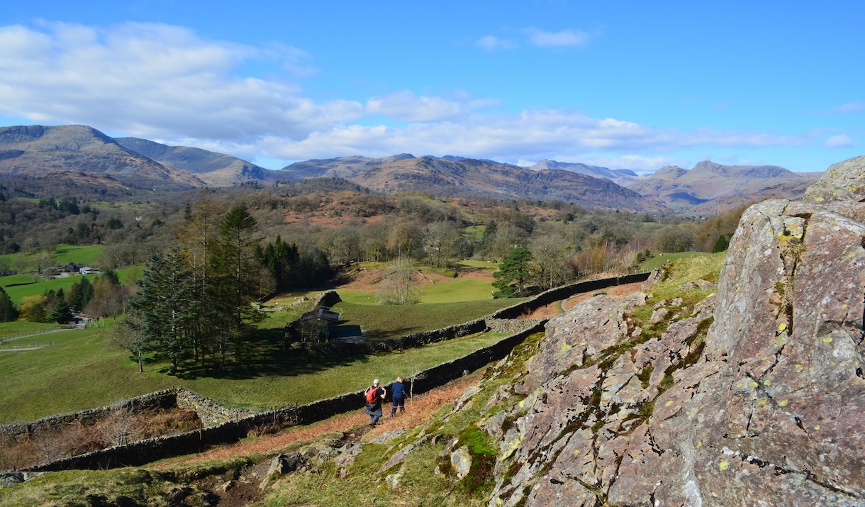 People walking along the slopes of Loughrigg Fell
