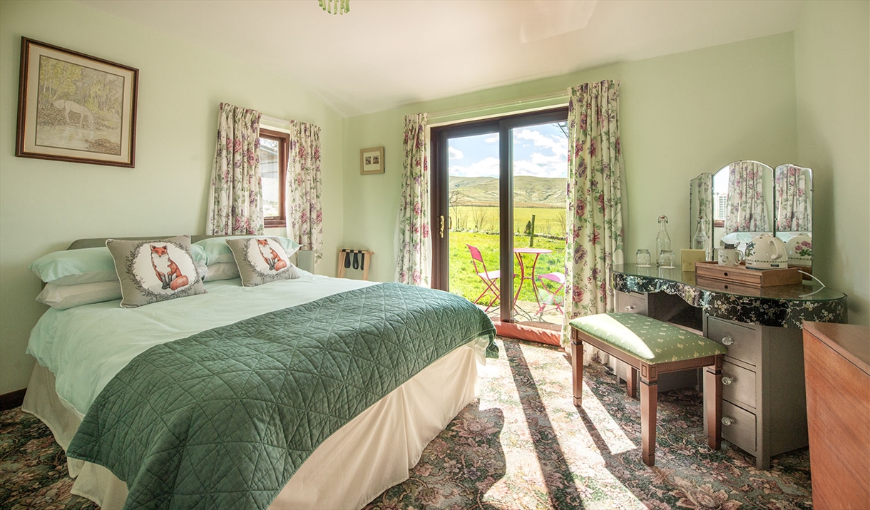 Double Bedroom with Dressing Table and Outdoor Access at High Greenside Bed and Breakfast in Ravenstonedale, Cumbria