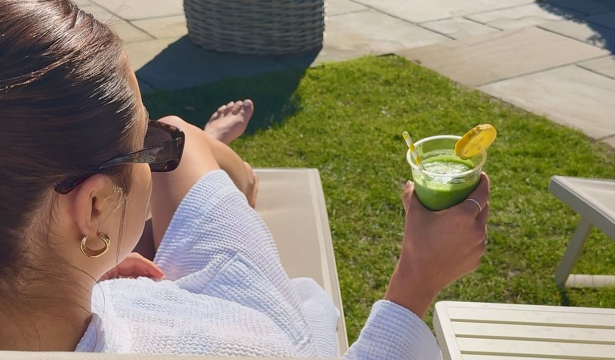 Sunbathing with a drink in hand