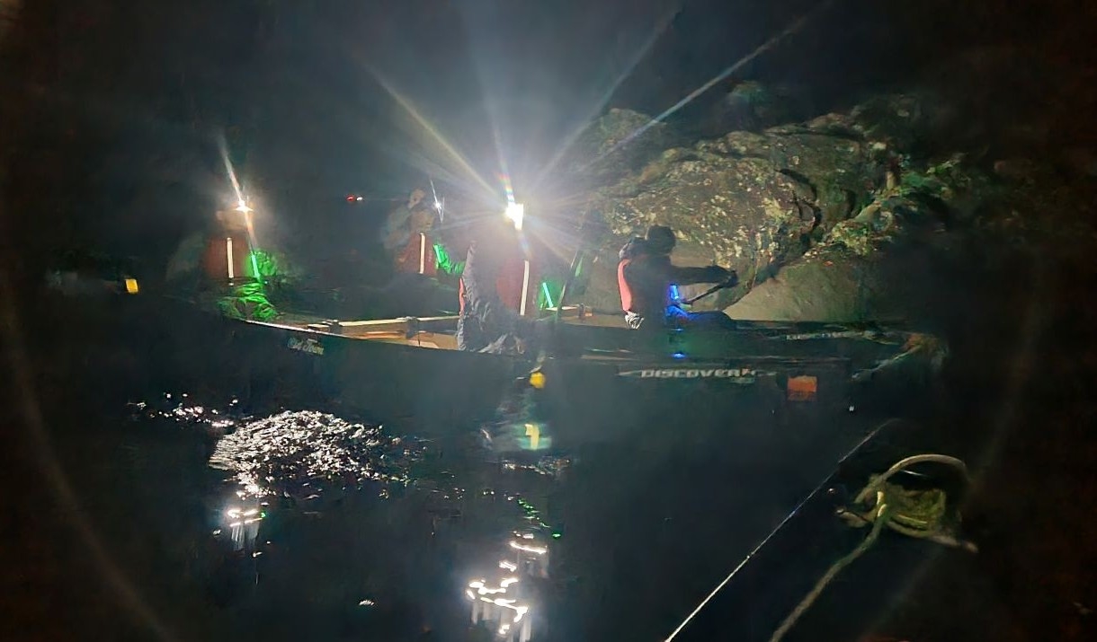 Canoeing at night in a rafted canoe with headtorches
