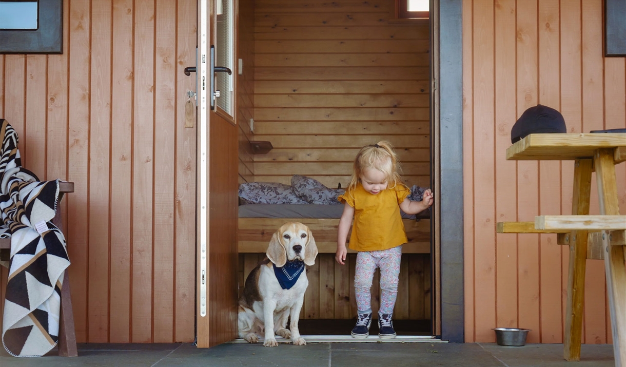 Child and Dog at Glamping Burrows at The Quiet Site Holiday Park in Ullswater, Lake District