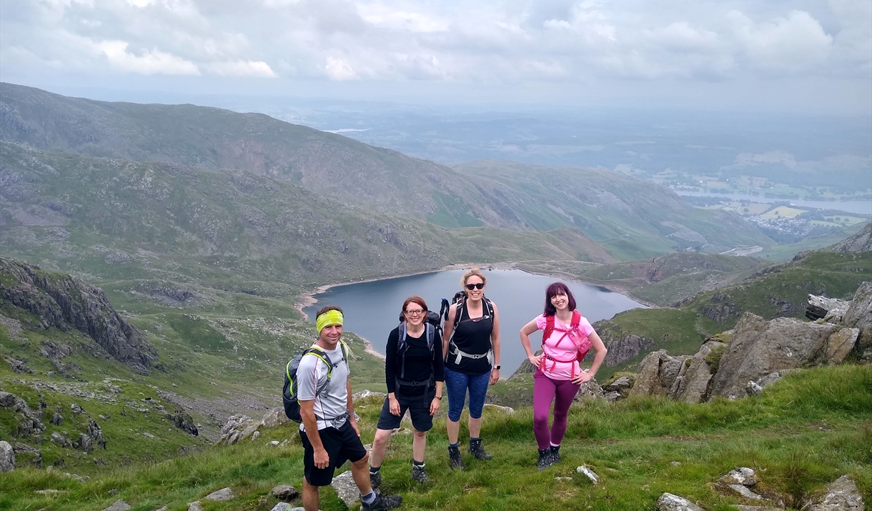 Four hikers on the Summit of the Old Man of Coniston