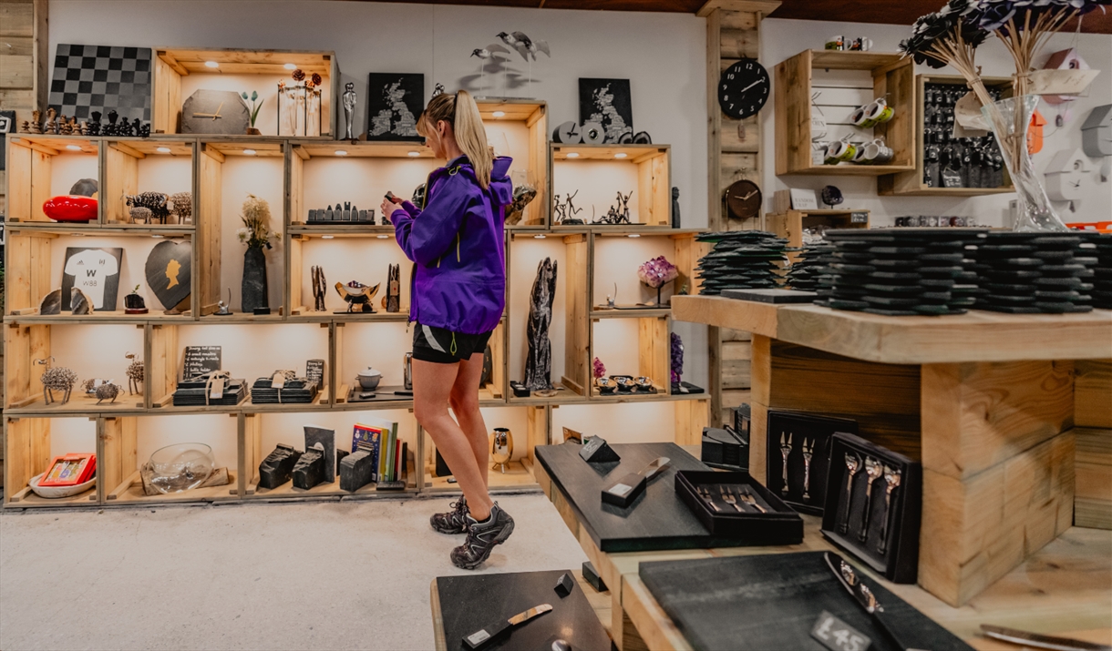 Visitor browsing shop at at Honister Slate Mine in Borrowdale, Lake District