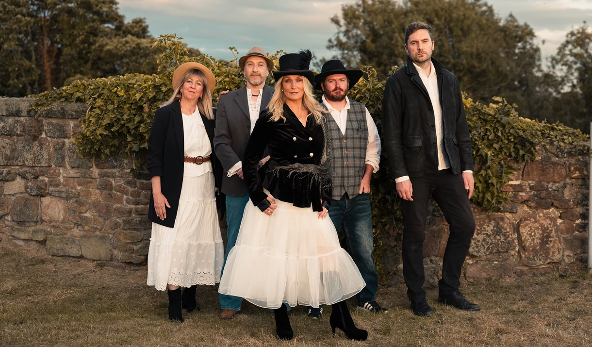 Fleetwood Nick'd stood infront of a stone wall