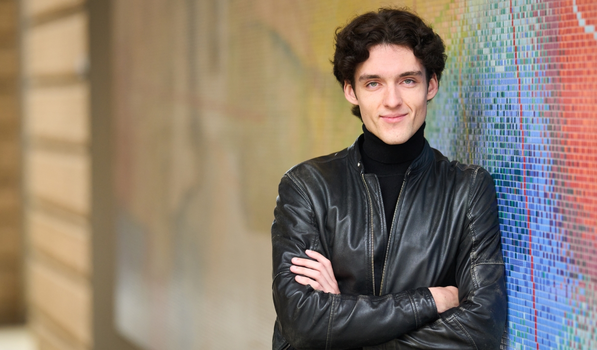 Ignas Maknickas stood leaning against a colourful wall