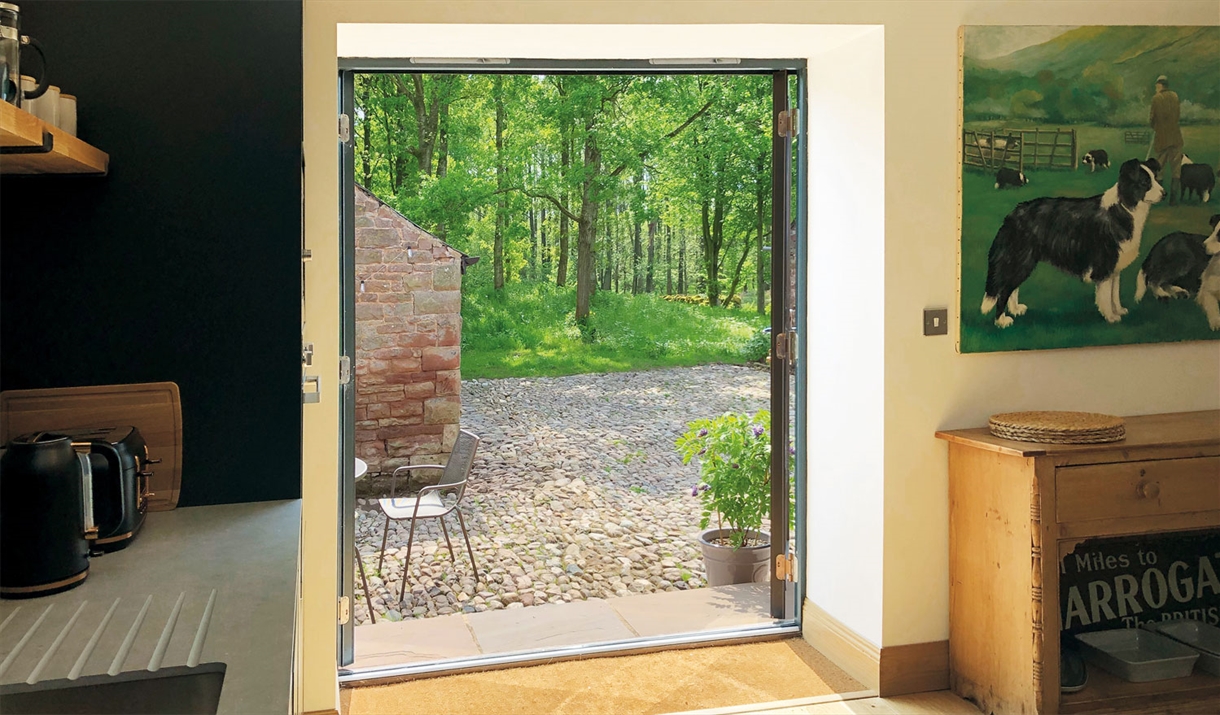 Double doors leading outside at The Barn at Linden Farm House in Langwathby, Cumbria