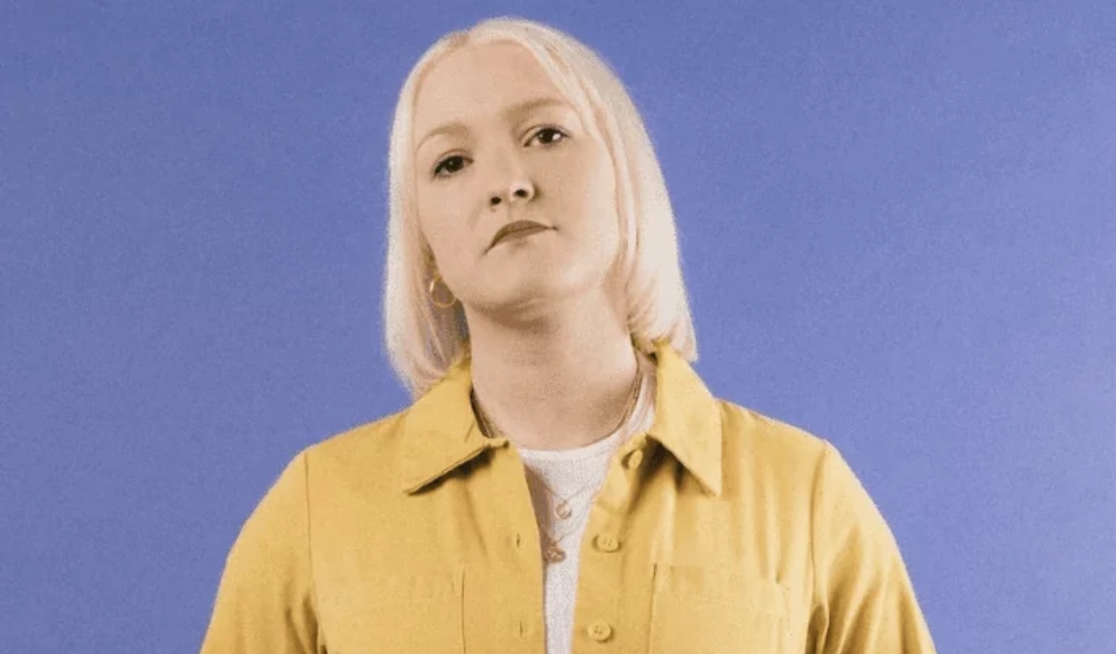 Person wearing yellow outfit looking into camera