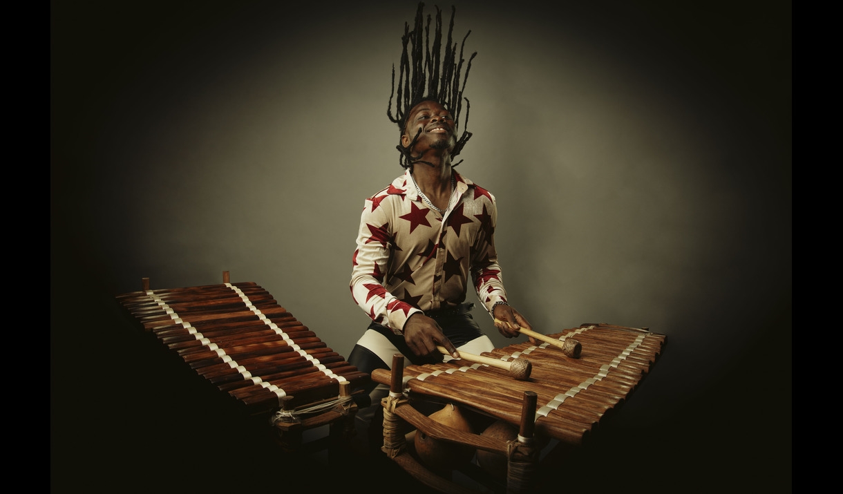 Photo of a man playing a wooden percussion instrument