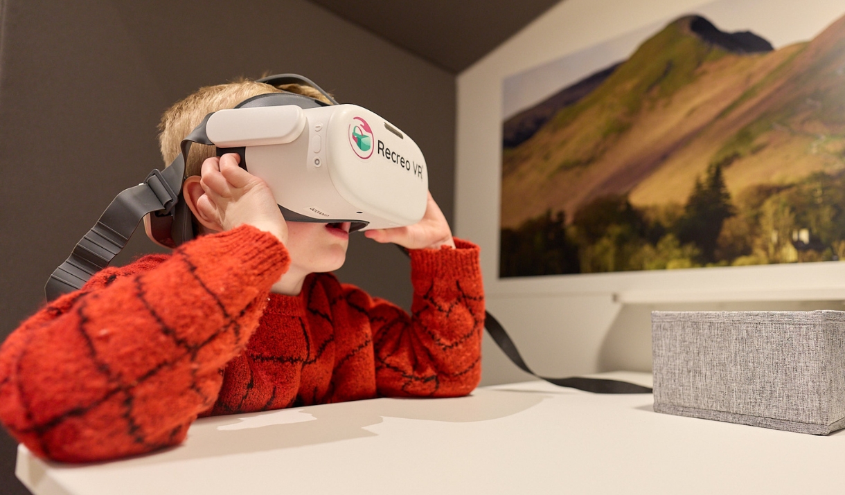 Child uses VR headset to view the Lake District.