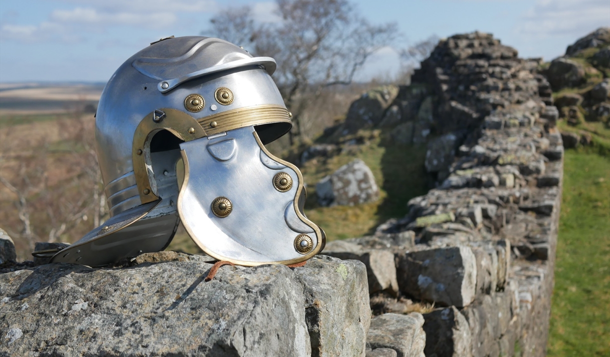 A Roman-style helmet resting on a Hadrian's wall