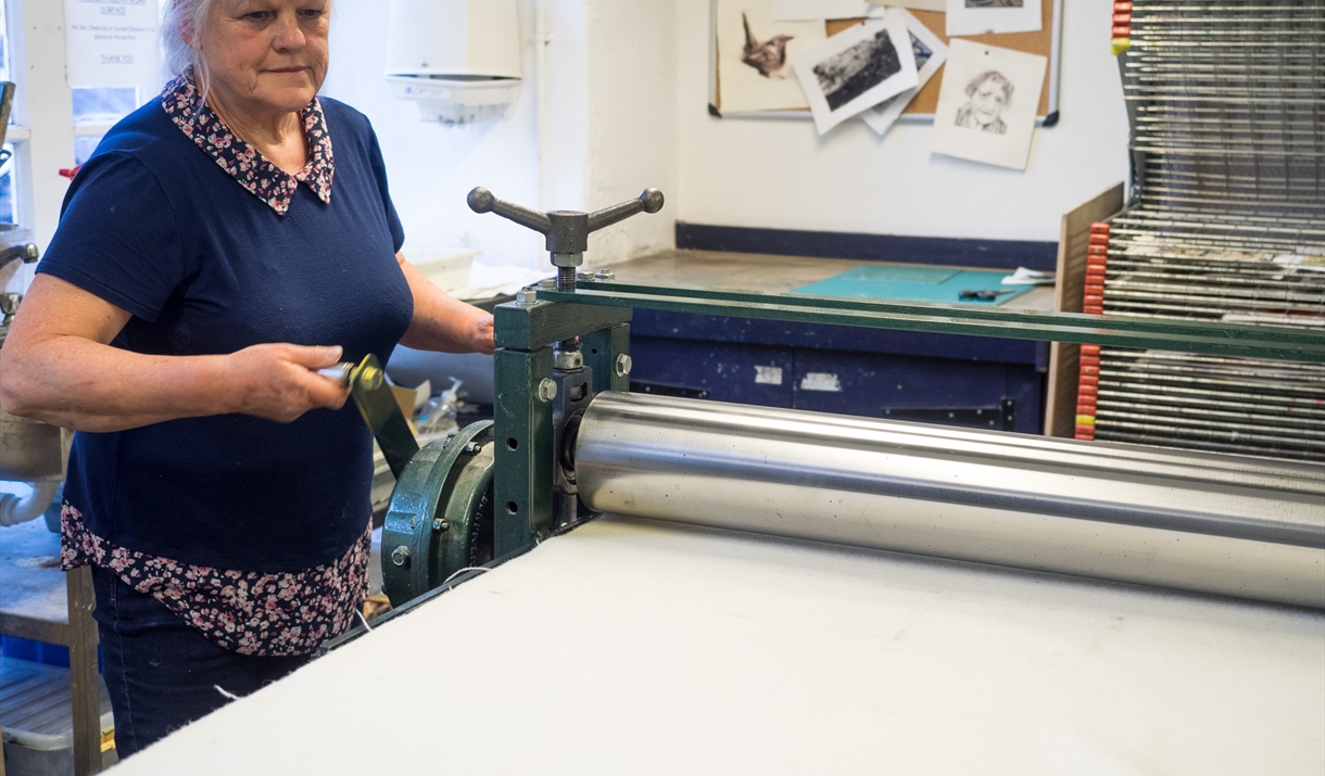 Women preparing a art print 
