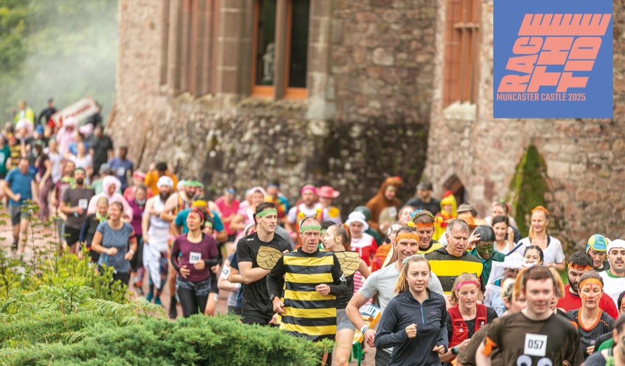 Runners in fancy dress running past Muncaster Castle as part of Race The Tide.