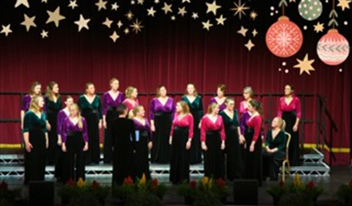 A choir on stage all looking in different directions