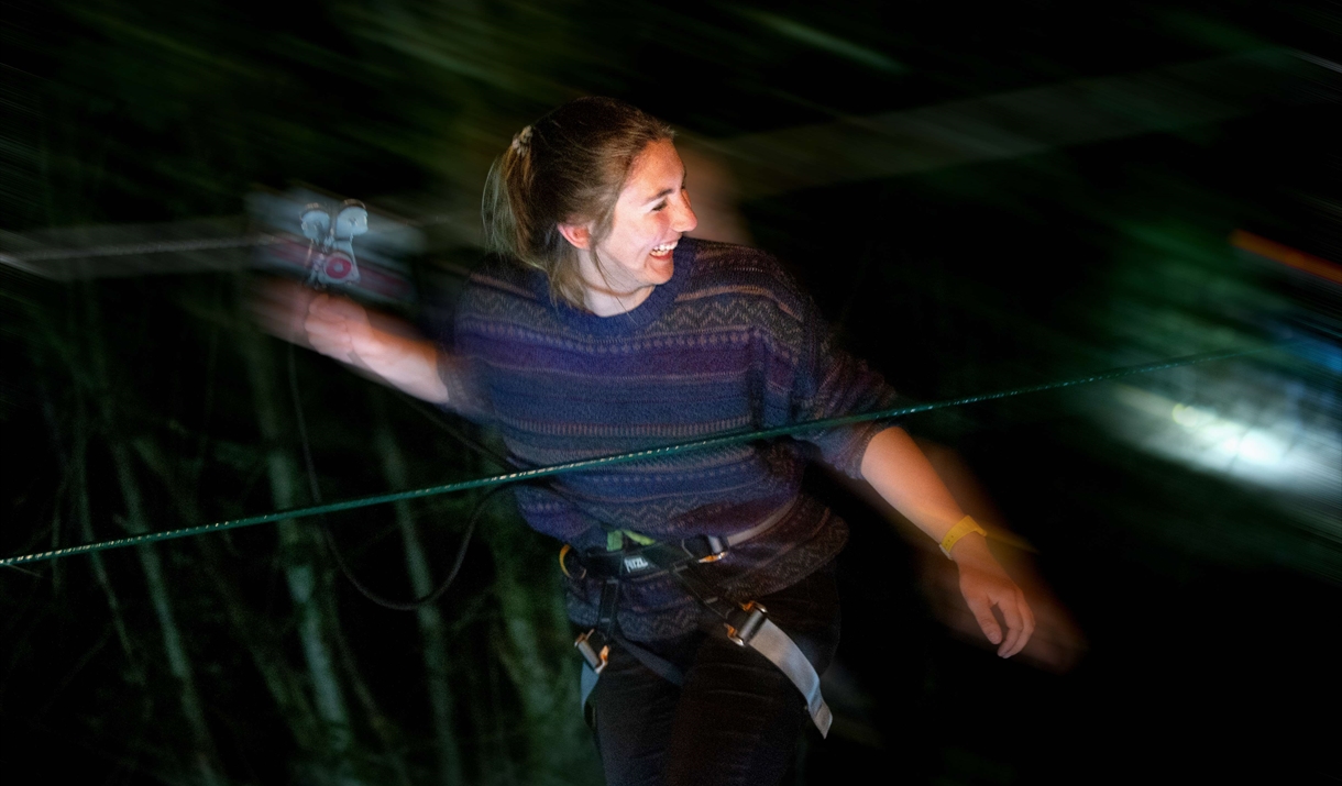 Person enjoying Go Ape in the dark