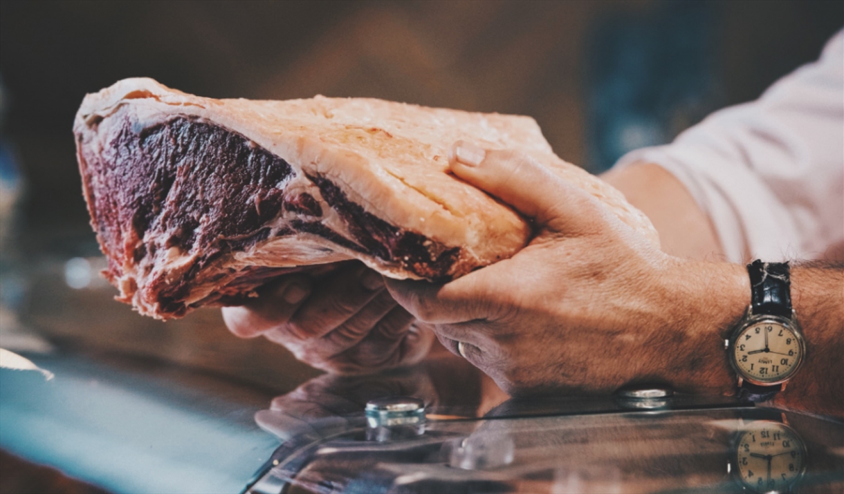 Butcher working at Tebay Services Farmshop and Kitchen in Tebay, Cumbria