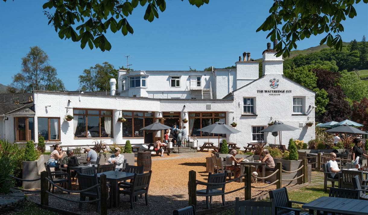 Visitors using outdoor seating at The Wateredge Inn in Ambleside, Lake District