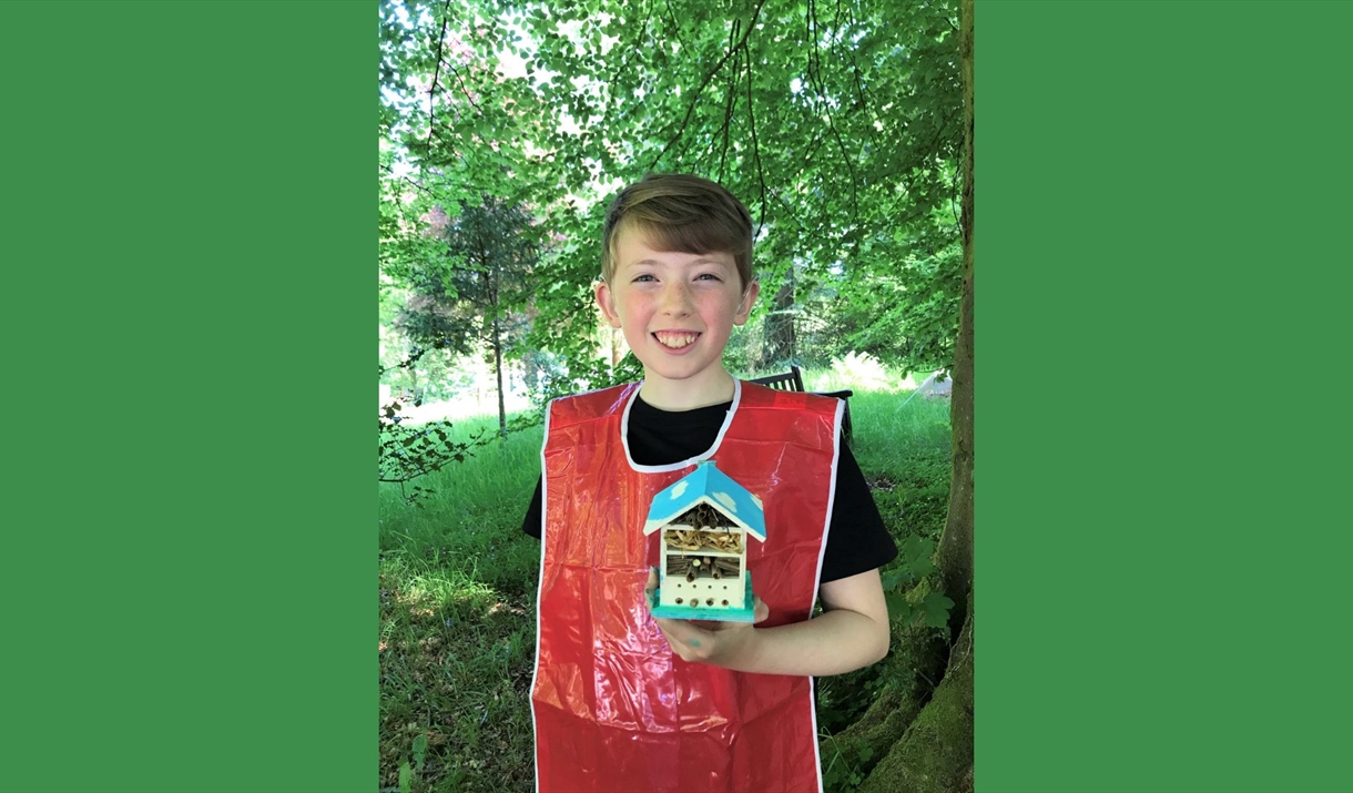 boy holding a bug hotel