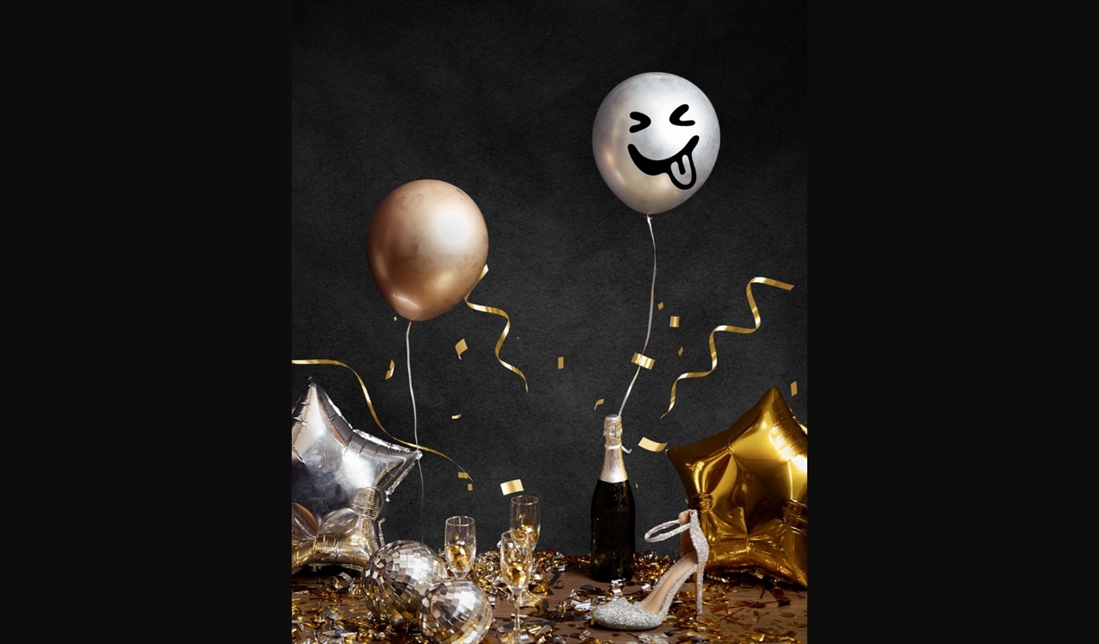 Celebration meal with balloons, high heels and champaign