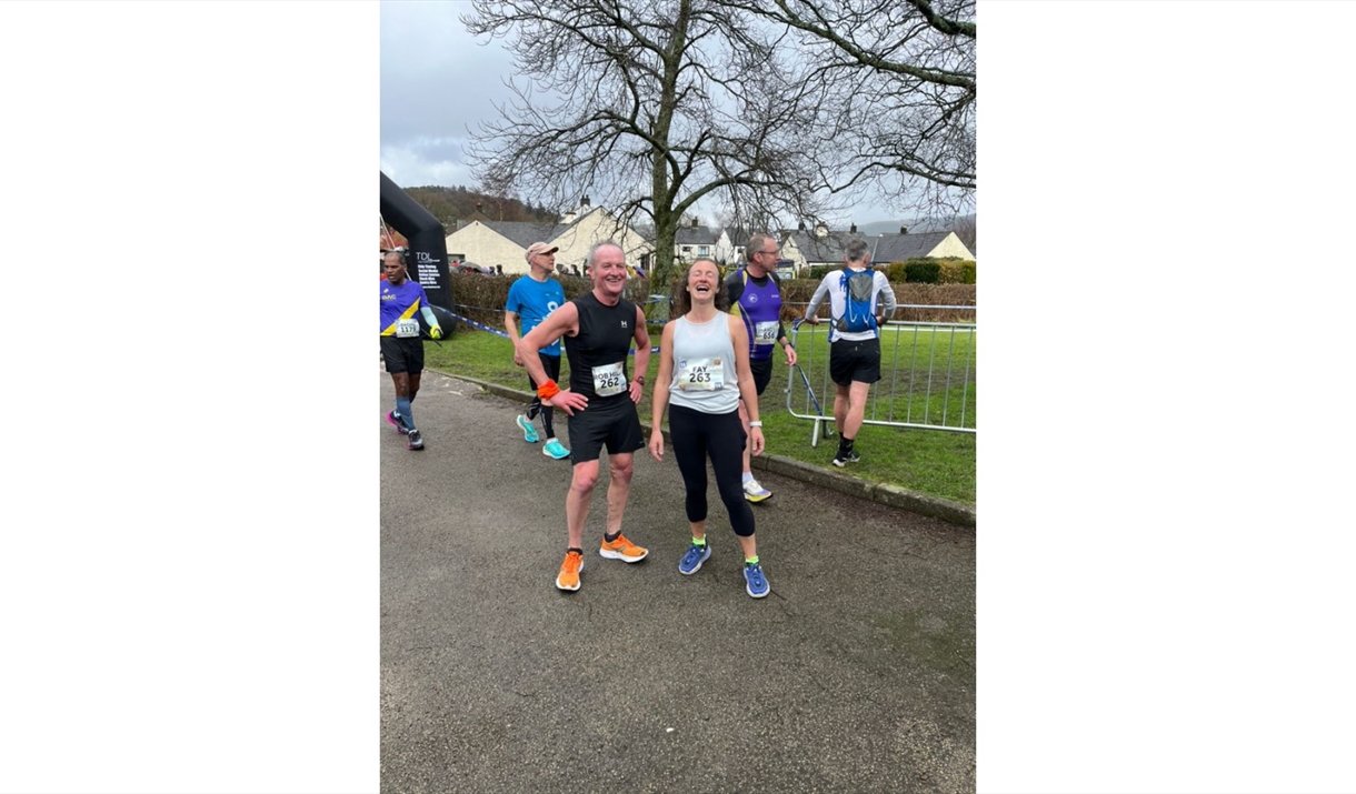 two runners smiling after completing a race