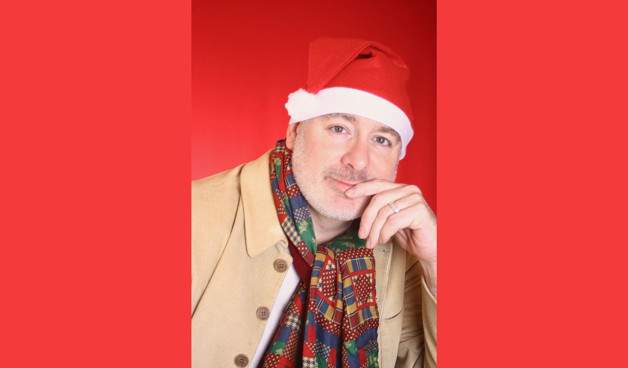 A close up of a man wearing a santa hat