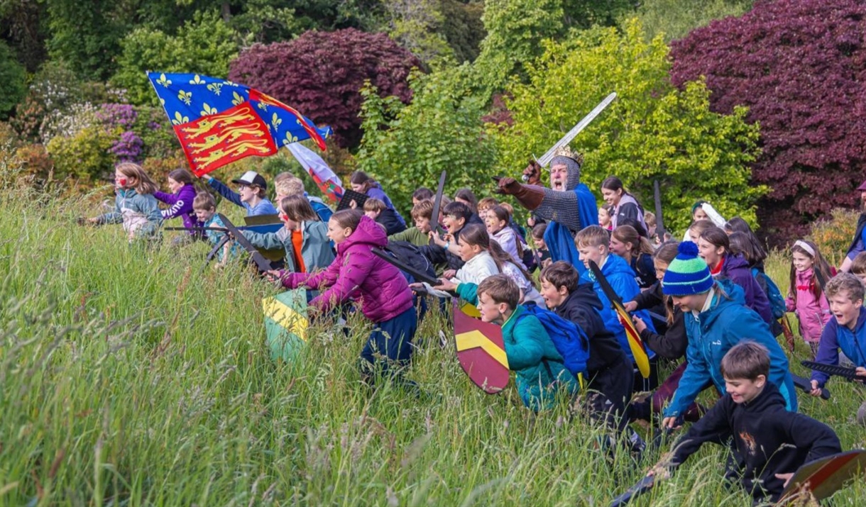 Children charging at Muncaster Castle with Peter Frost-Pennington dressed as the King of the North.