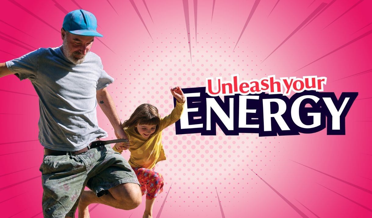 Person and child jumping outdoors against a bright pink graphic background with bold text reading "Unleash Your Energy".