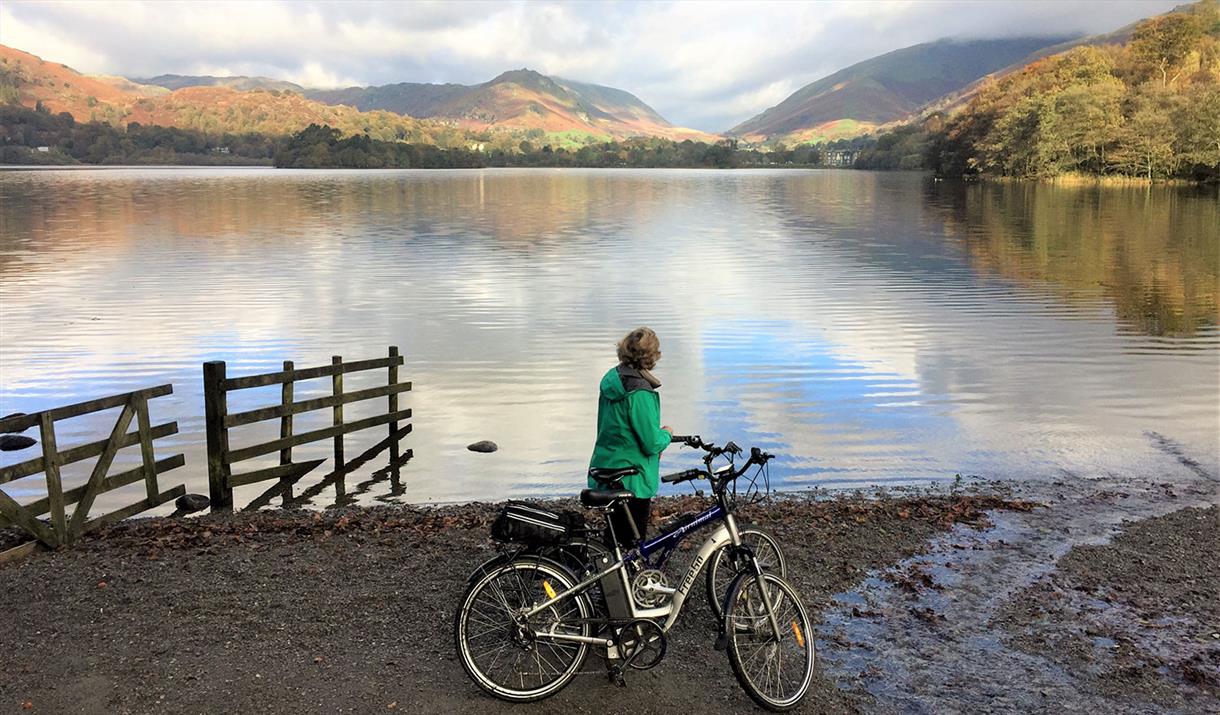 Cyclist Standing Lakeside on a Cycling Holiday in the Lake District, Cumbria from The Carter Company