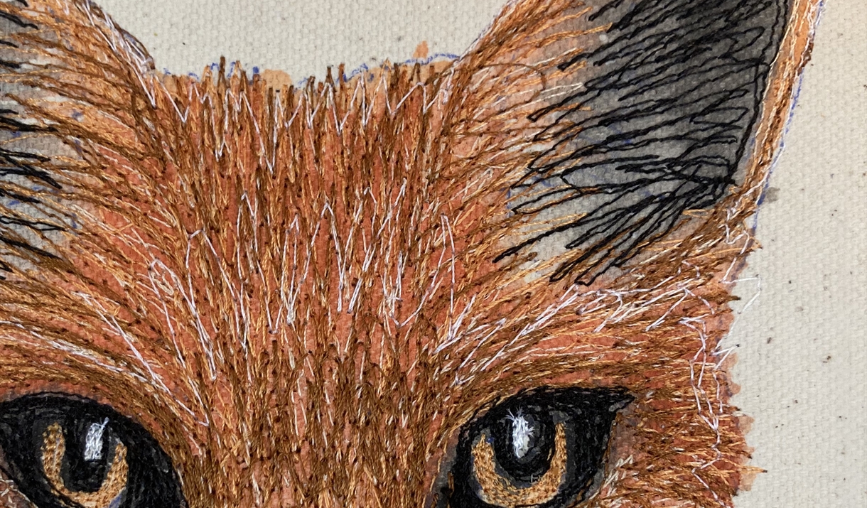 Close-up of a fox's face illustrated in stitch, showcasing detailed fur texture and expressive eyes.