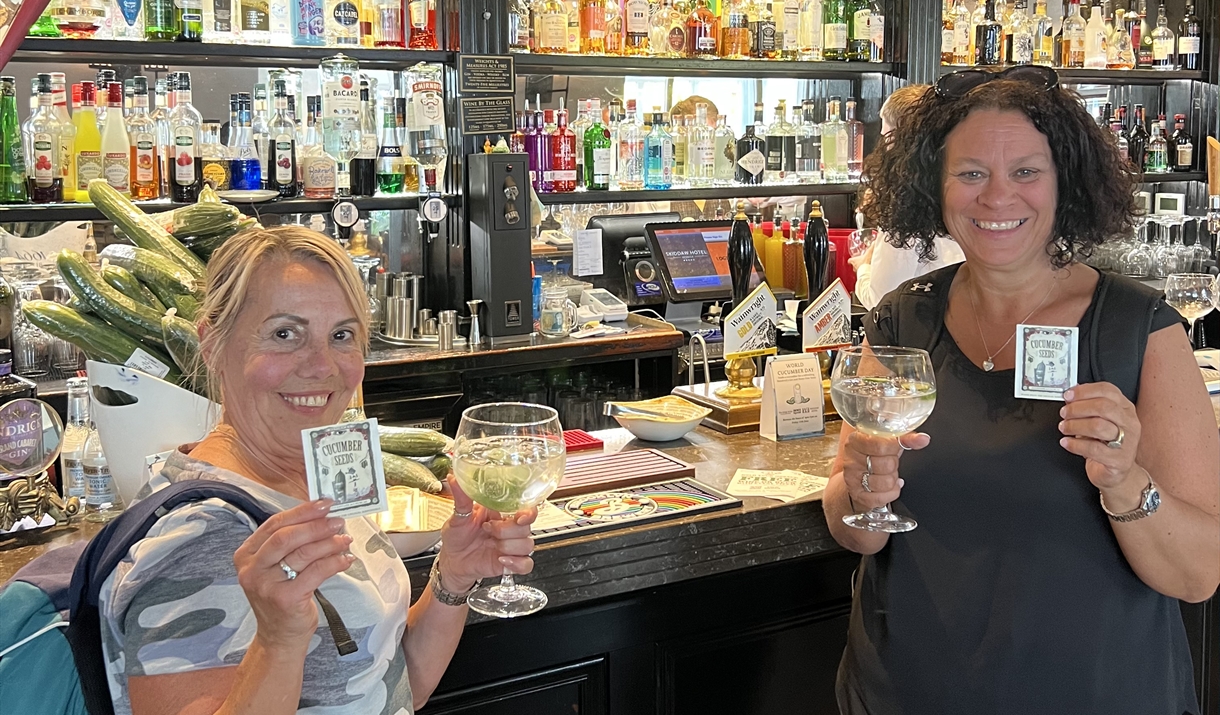 Customers holding their free Gin & Tonic