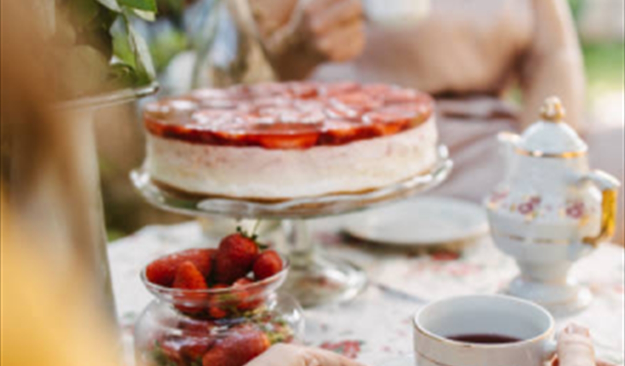 two people sat around an afternoon tea spread