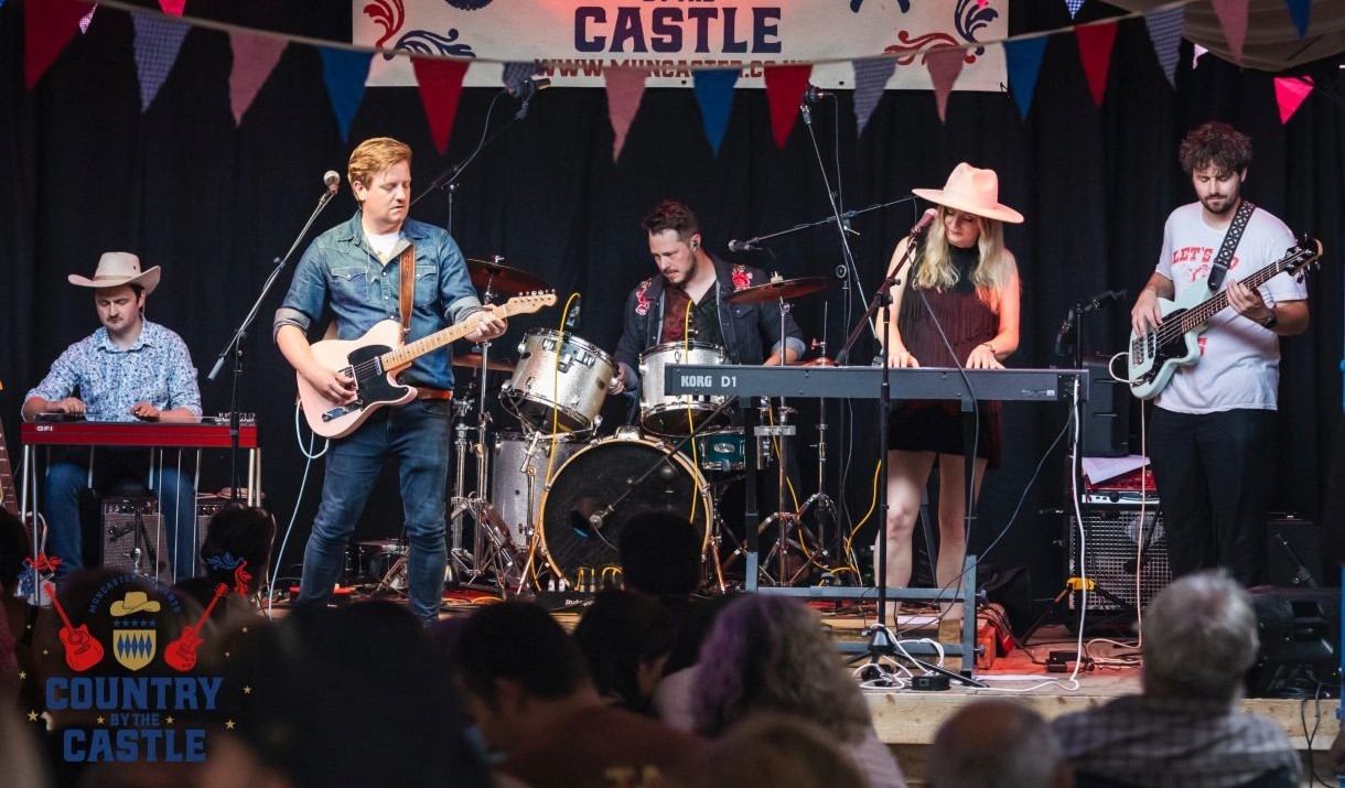 Band performing at the Countrt by the Castle Festival at Muncaster Castle