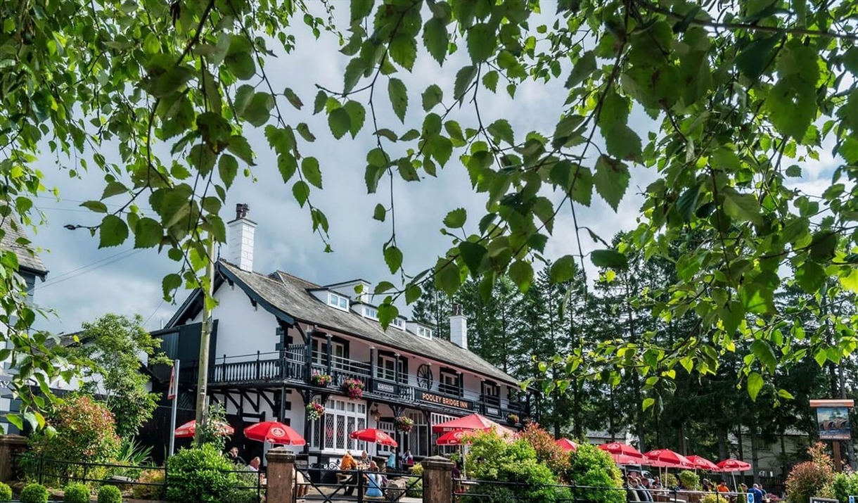 Exterior and lush plants in the summer at Pooley Bridge Inn in the Lake District, Cumbria
