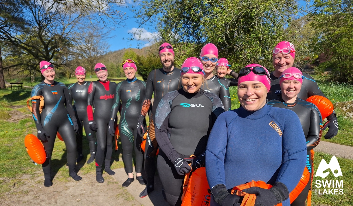 swimmers stood on shoreline with Swim the Lakes