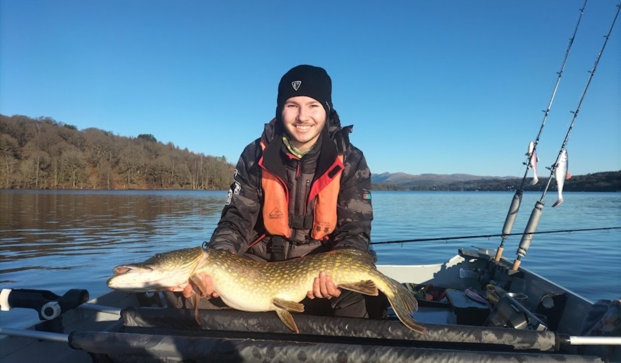 Visitor posing with fish caught on a fishing trip with West Pennine Angling Solutions in the Lake District, Cumbria
