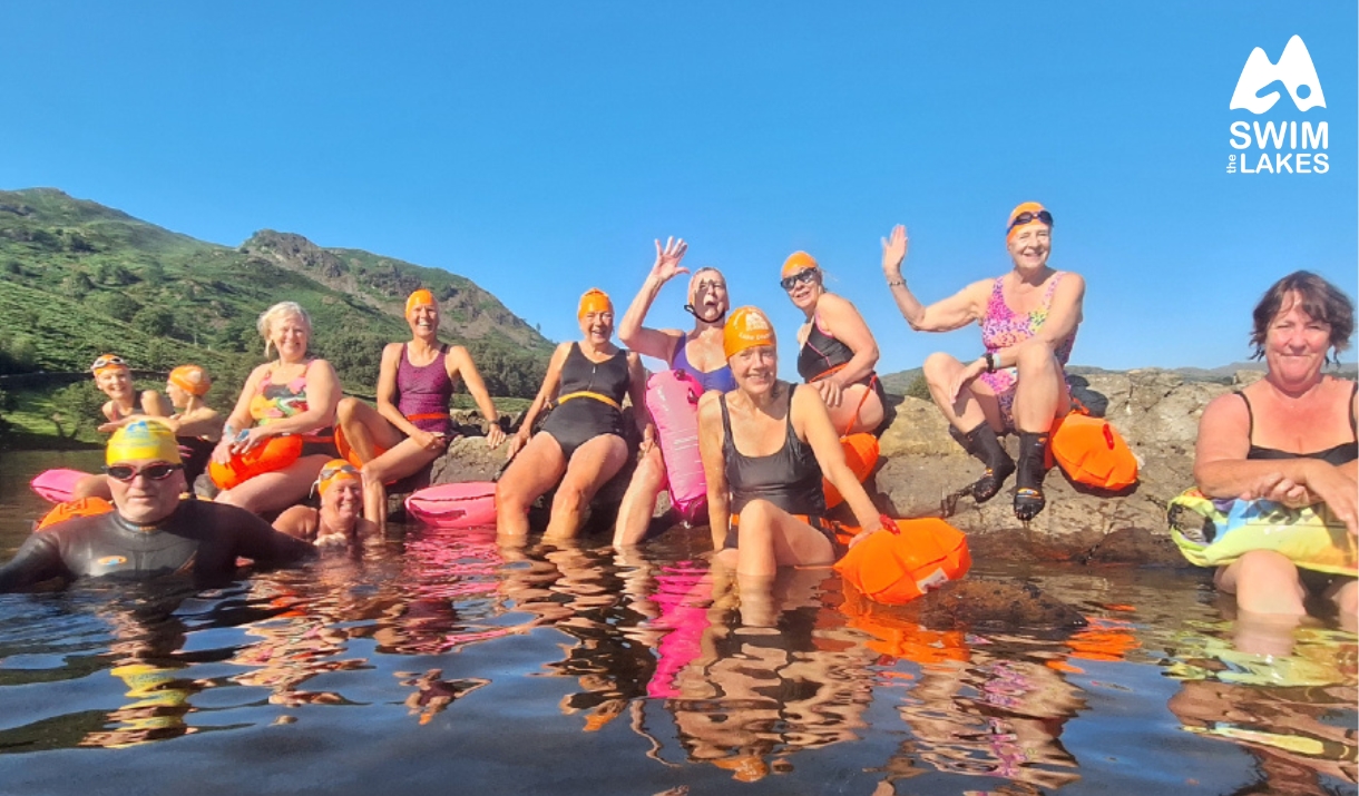 wild swimmers with Swim the Lakes sat on the edge of a Lake District tarn